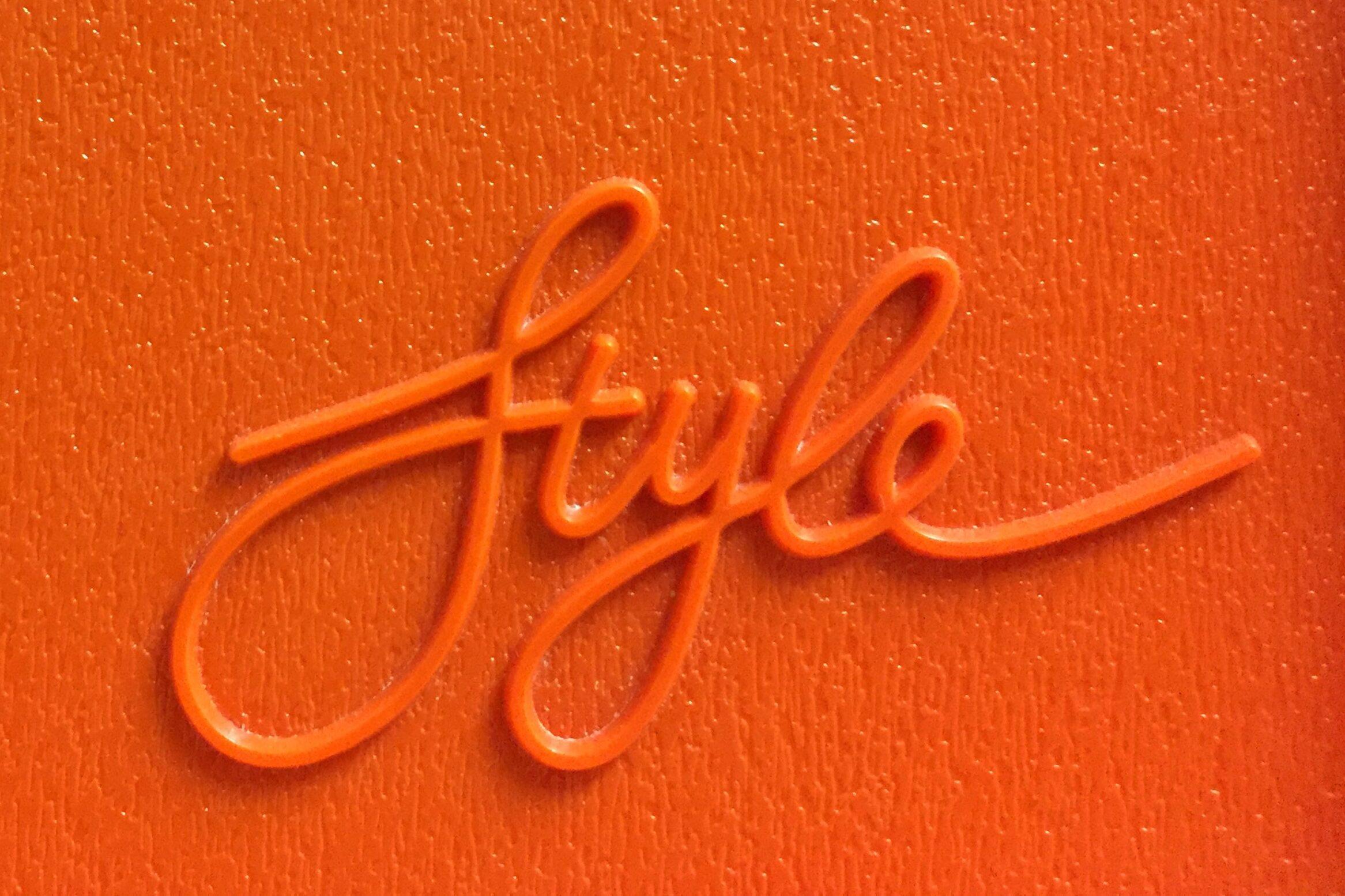 orange background with the word "style" in raised cursive letters