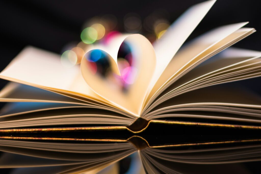 Open book with pages folded into a heart. story collection for nonprofits. 