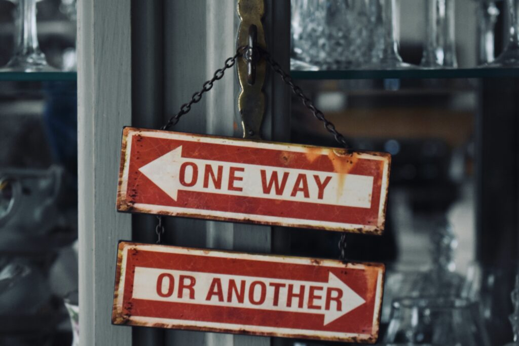 two signs pointing is different directions saying one way  and or another