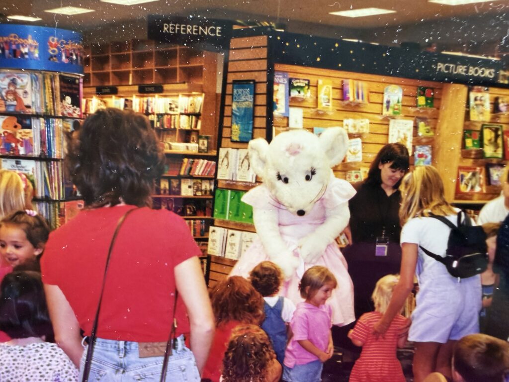 An old photograph of storytime at Borders Books and Music with Angelina Ballerina costume character.